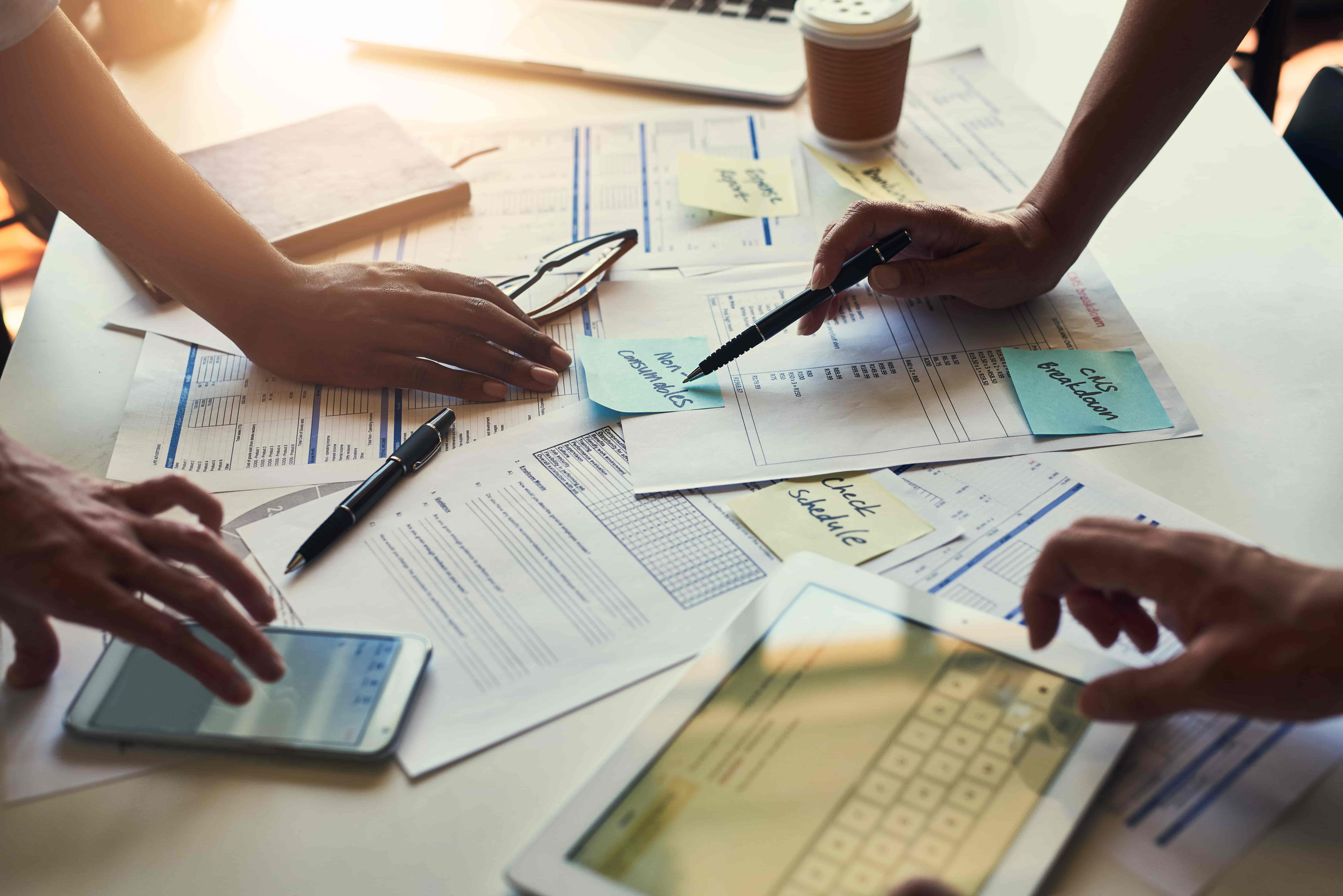 Documents technology and hands of business people in meeting for accounting paperwork or finance