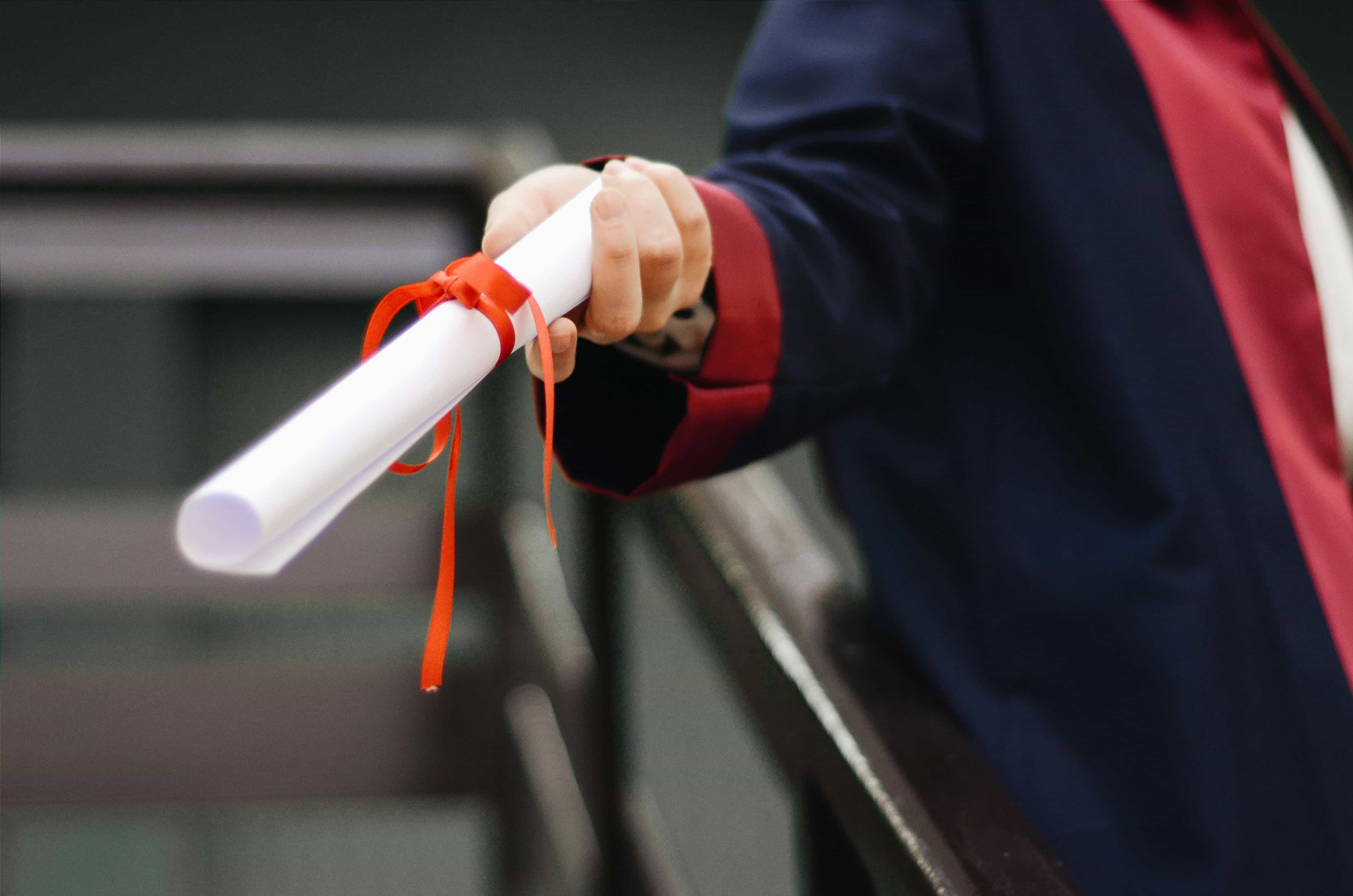person holding a rolled paper with lace